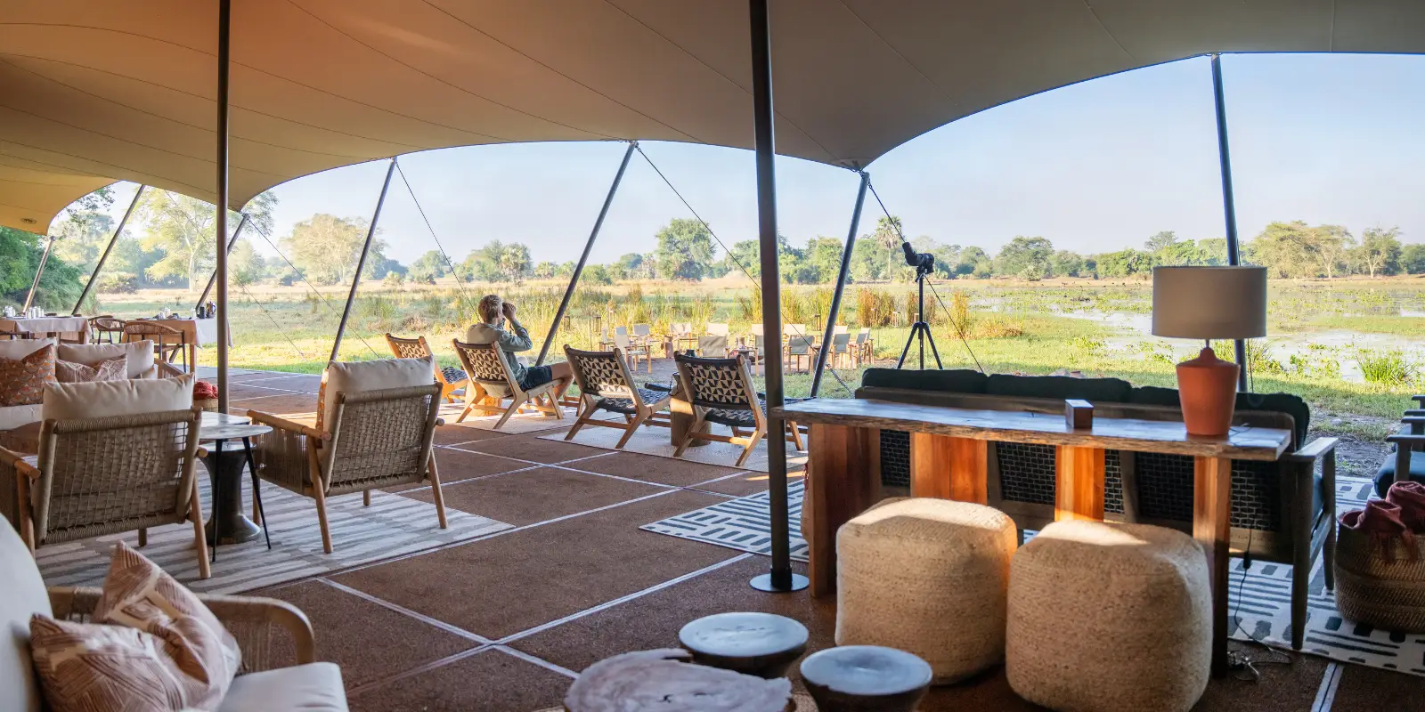 Guest enjoying observing wildlife from the main living area at Chicari Camp, Mozambique.