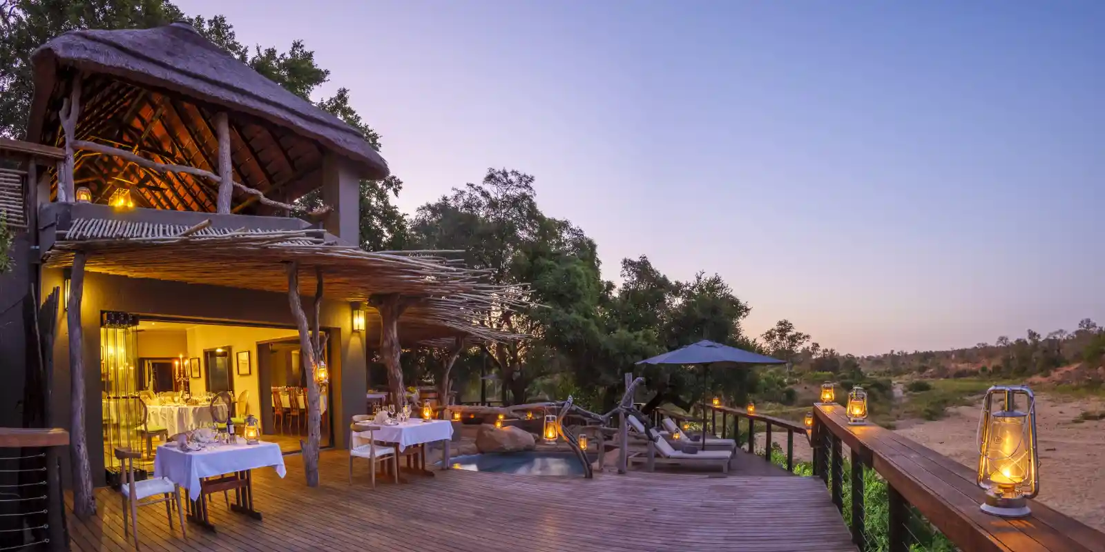 Sunset view of Jock Safari Lodge's dining area and decking.