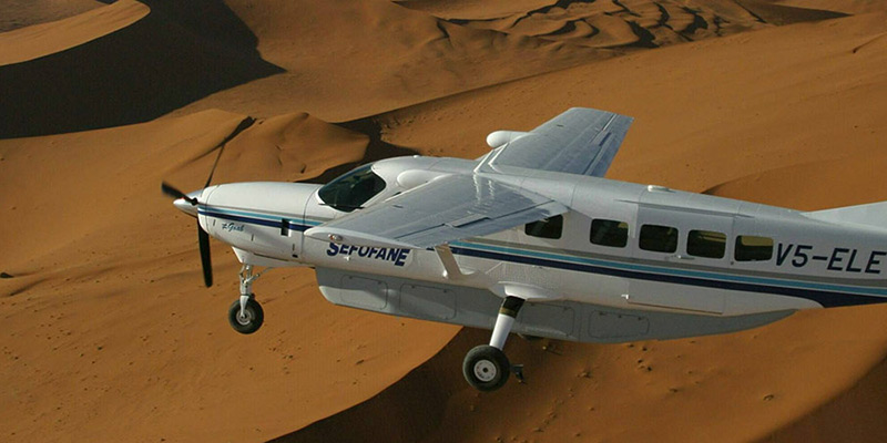 Aircraft flying over Namibian desert