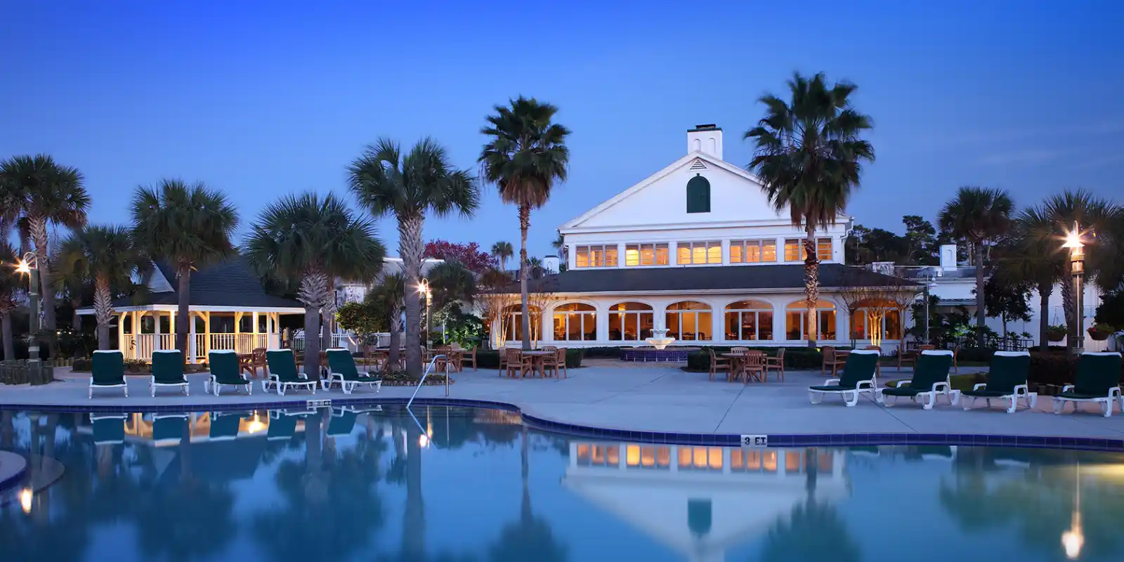 View of Plantation Resort in Florida, with swimming pool, at dusk.