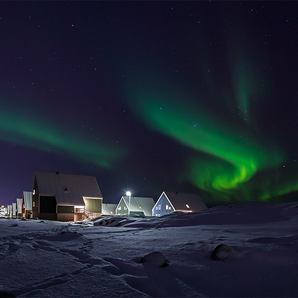 Northern lights and village in Greenland