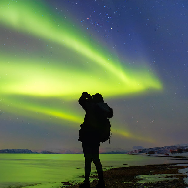 Photographer capturing the northern lights
