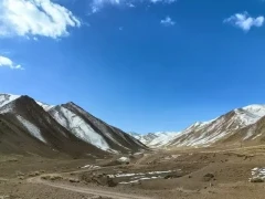 Mountains under blue skies in the Gouli Valley, Qinghai, China.