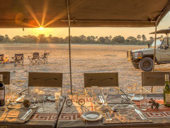 Dining table and safari vehicle in Botswana