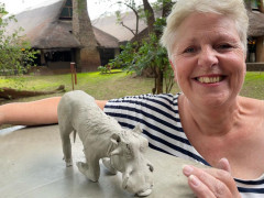 Client with warthog sculpture on our Wildlife Art Safari in South Luangwa, Zambia