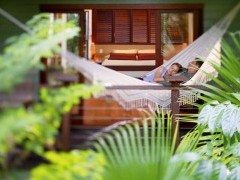 Guests relaxing in a hammock at Silky Oaks Lodge, Queensland, Australia.