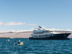 Kayakers and Origin vessel in the Galapagos.