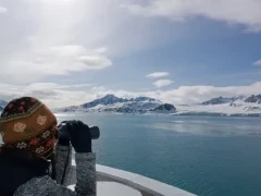 Admiring the polar landscape with a pair of binoculars, Svalbard.
