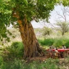 Guests seated outside at Ol Gaboli Lodge, Kenya.