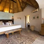 View of the bedroom in the garden suite at Klaserie Drift Misava Safari Camp.