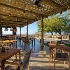 View of the outside dining area and bar at Klaserie Drift Misava Safari Camp.