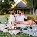 Couple enjoying a picnic in the grounds of Simbavati Camp George, in Klaserie Private Nature Reserve.