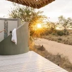 An external view of the luxury suite private outdoor shower facility at Simbavati Camp George.