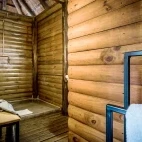 Bathroom facility with waterfall shower.