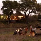 Sunset view of Hamiltons Tented Camp from across the river, Kruger National Park, South Africa.