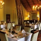 View of the dining area at Imbali Safari Lodge. The lodge really brings the outside in, with an ancient jackalberry tree growing through the room.