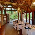 The lodge dining room, complete with log burner. Rhino Post Safari Lodge.