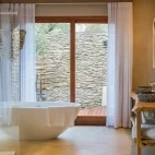 Dulini River Lodge's suite bathrooms, featuring freestanding bath.