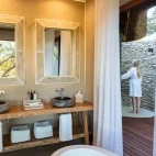 Suite's double vanity area, with outdoor shower facility, Dulini River Lodge.