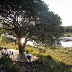 View of the outdoor decked area at Dulini River Lodge, by the Sand river.