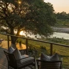 View from decking overlooking the Sand River at sunset, Dulini River Lodge, South Africa. 