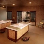 The treatment room at Amani Spa in Sabi Sabi Earth Lodge, featuring two massage beds.