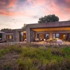 An exterior view of the architectural delight that is the private Amber Villa. The villa has space for up to four adults and two children, and has access to a private vehicle and guide.