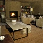 The cosy and comfortable lounge space, complete with library and log fire.