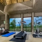 The gym facilities at Sabi Sabi Earth Lodge, with views of Sabi Sands Private Game Reserve.