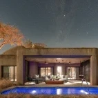 An external view of one of Sabi Sabi Earth Lodge's luxury suites, featuring private outdoor lounge area and pool.
