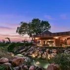 View of the lodge set amongst Sabi Sands Private Game Reserve, with tasteful water feature.