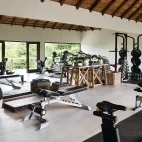 On-site gym area for guests at Varty Camp to use. Equipment includes rowing machines, bikes, weights and bench press.