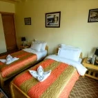 Twin bedroom at Snow Leopard Lodge in Ulley Valley, India.
