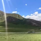 Vehicles exploring the Gouli Valley, Qinghai, China.