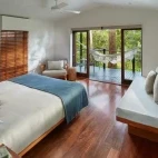 Interior view of the riverhouse suite, complete with balcony and hammock, at Silky Oaks Lodge, Australia.