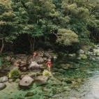 Guests enjoying time by the river near Silky Oaks Lodge, Australia.