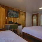 View of a standard room, with wardrobe, desk and TV, at Naturezas, Brazil.