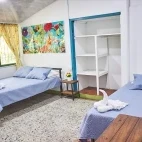 Twin room with double and single bed setup, at Rancho Camana, Colombia.