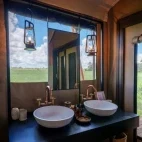 A dual vanity unit in an en suite bathroom at Karangoma, Botswana.