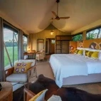 Example of one of the guest suites, with large bed and lounge area overlooking expansive views. At Karangoma, Botswana.