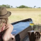 Guest relaxing in a mokoro bath, Kweene Trails Botswana.