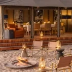 Dining seating at Shinde Footsteps Camp, and small firepit with outdoor seating.