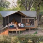 Guests enjoying their private deck at the exclusive Shinde Footsteps Camp, Botswana.