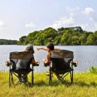 Guests sitting outside at Loango Savannah Camp, Gabon