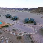 Aerial panorama of some of the camp, including swimming pool and lounge deck.