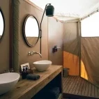 An en suite bathroom facility at Hoanib Valley Camp, with his and hers sinks.