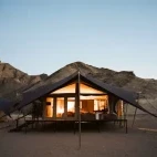Evening external view of one of the tented accommodations at Hoanib Valley Camp.