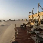 External view of the communal deck area at Shipwreck Lodge, complete with lounge chairs.