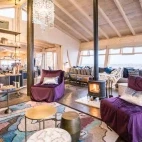 The main lounge area, leading into the dining area and breakfast bar.