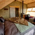 Example of a twin room accommodation, complete with wood burner and desert views.